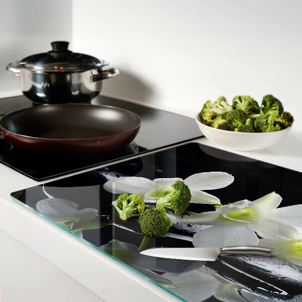Chopping board glass Orchids on a black background