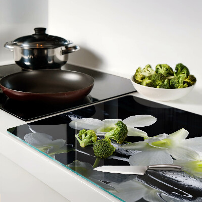 Chopping board glass Orchids on a black background