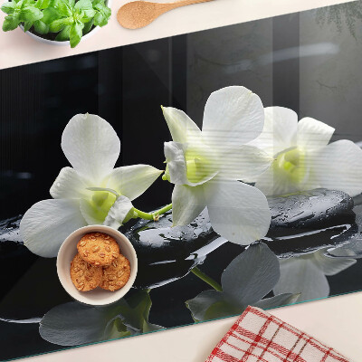 Chopping board glass Orchids on a black background