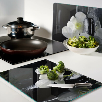 Chopping board glass Orchids on a black background