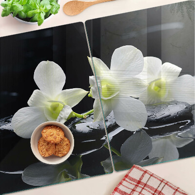 Chopping board glass Orchids on a black background
