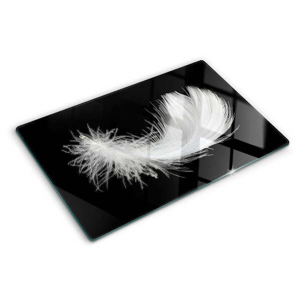 Glass chopping board Feather on a black background