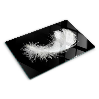 Glass chopping board Feather on a black background