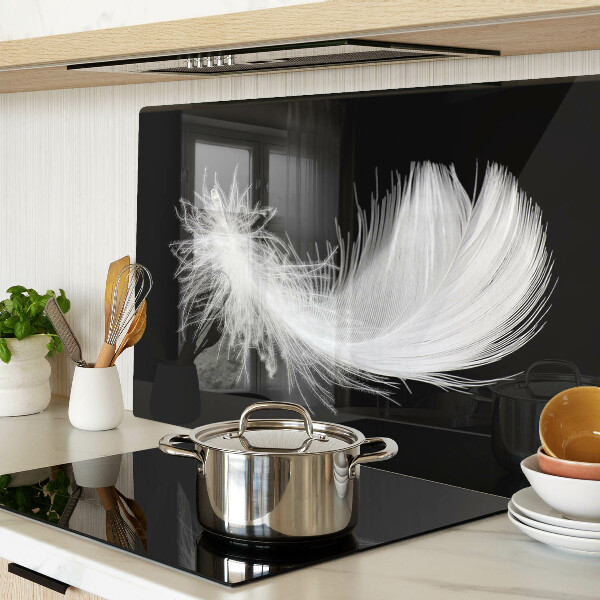 Glass chopping board Feather on a black background
