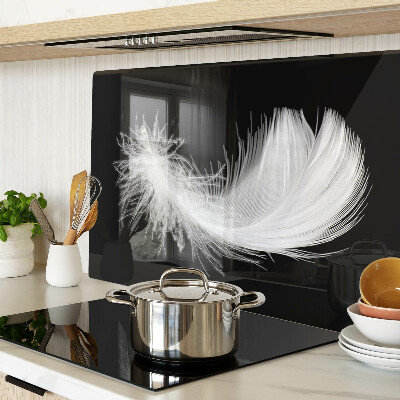 Glass chopping board Feather on a black background
