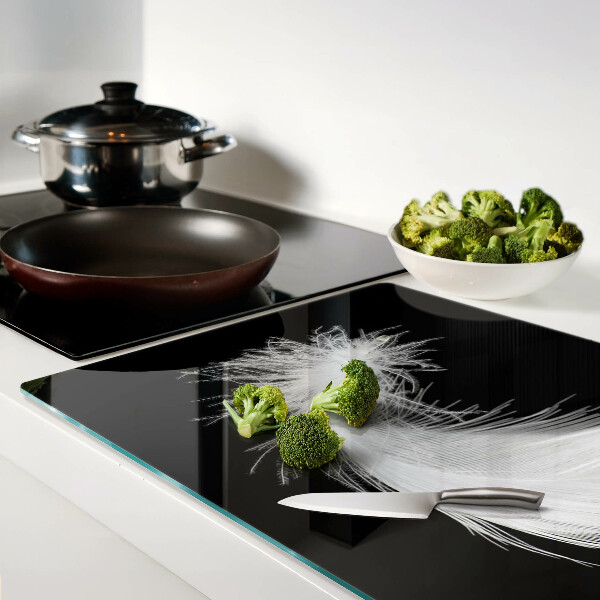 Glass chopping board Feather on a black background