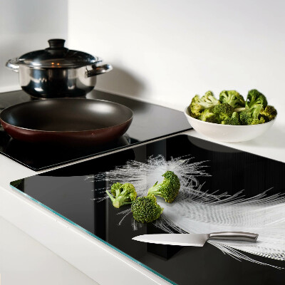 Glass chopping board Feather on a black background