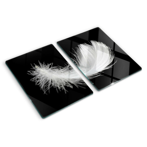 Glass chopping board Feather on a black background