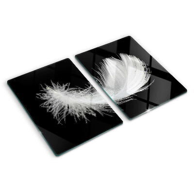 Glass chopping board Feather on a black background