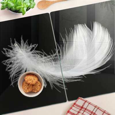 Glass chopping board Feather on a black background