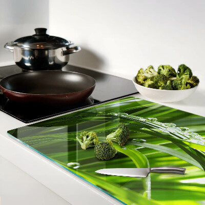 Glass kitchen board Drops of water on the grass