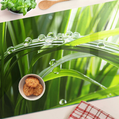 Glass kitchen board Drops of water on the grass