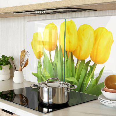 Glass kitchen board Yellow tulips on a green background