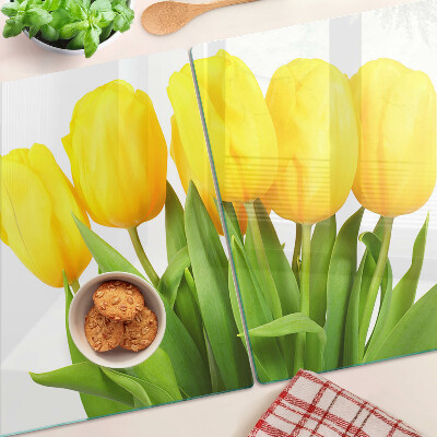 Glass kitchen board Yellow tulips on a green background
