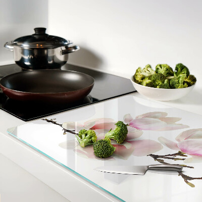 Chopping board glass Magnolia flowers on a branch