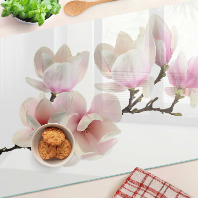 Chopping board glass Magnolia flowers on a branch