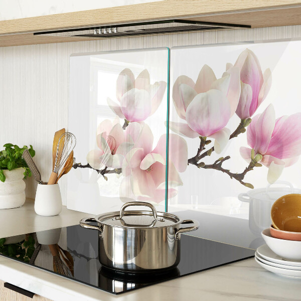 Chopping board glass Magnolia flowers on a branch