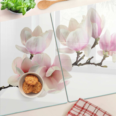 Chopping board glass Magnolia flowers on a branch