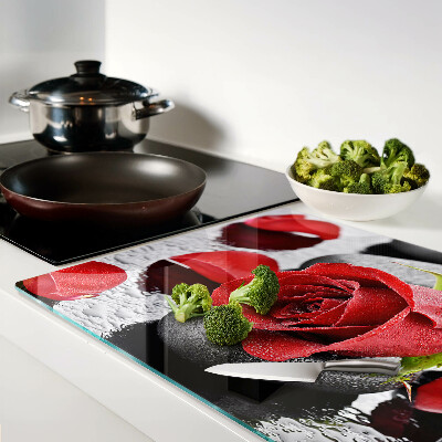 Glass cutting board Rose on stones with water drops