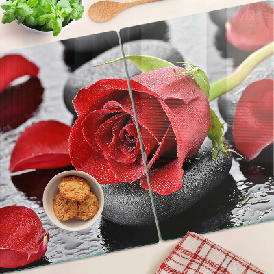 Glass cutting board Rose on stones with water drops