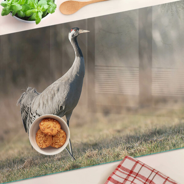Glass chopping board A crane against the backdrop of a landscape
