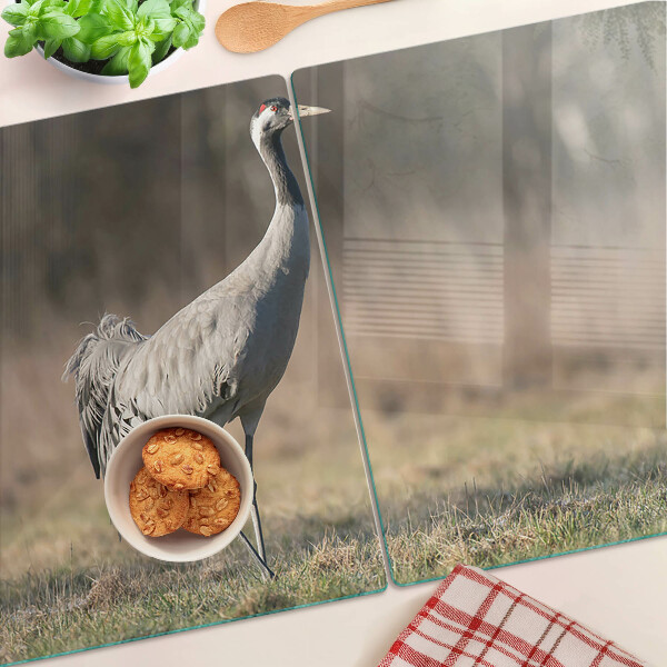 Glass chopping board A crane against the backdrop of a landscape