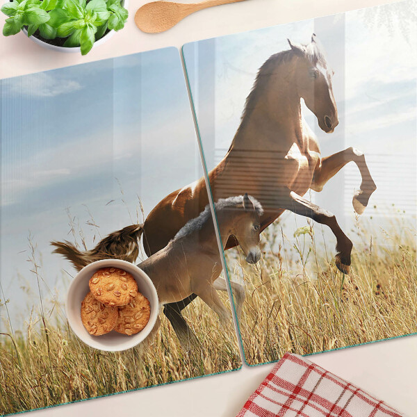 Glass chopping board Horses in a meadow in the sun