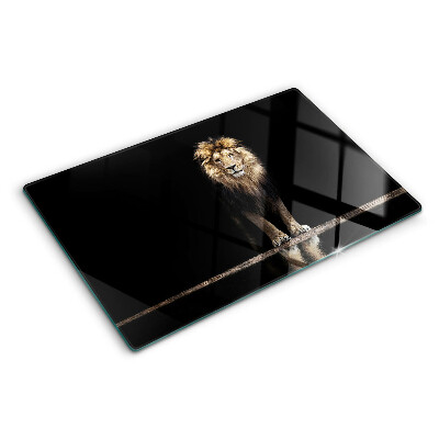 Glass kitchen board Lion on a dark background