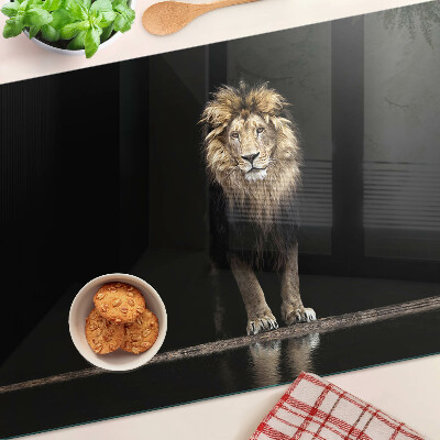 Glass kitchen board Lion on a dark background