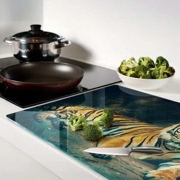Glass cutting board A tiger lying on the rocks