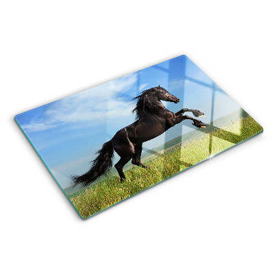 Glass cutting board Black horse in the meadow