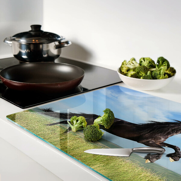 Glass cutting board Black horse in the meadow
