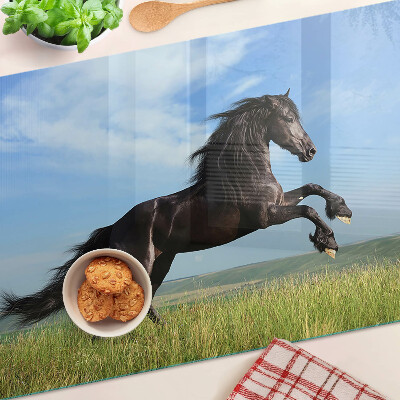 Glass cutting board Black horse in the meadow