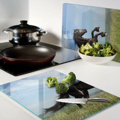 Glass cutting board Black horse in the meadow