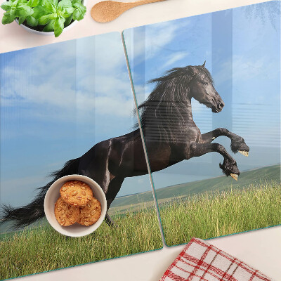 Glass cutting board Black horse in the meadow