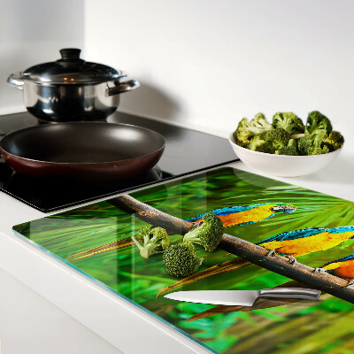 Glass kitchen board Parrots on a branch in the tropics