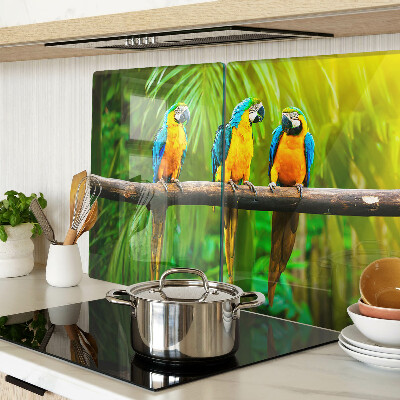 Glass kitchen board Parrots on a branch in the tropics