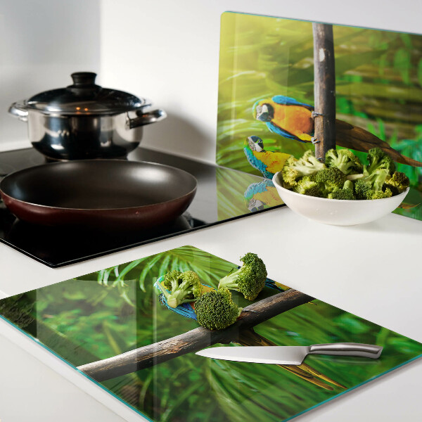 Glass kitchen board Parrots on a branch in the tropics
