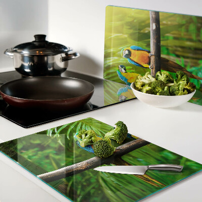 Glass kitchen board Parrots on a branch in the tropics