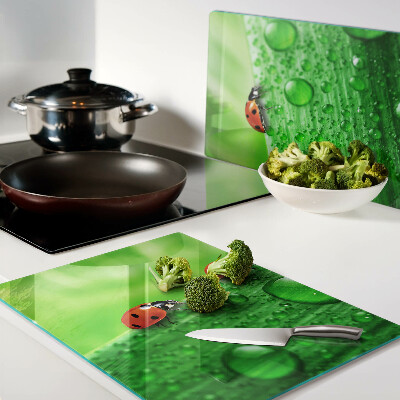 Cutting board Ladybugs on a green background