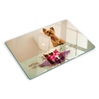 Glass chopping board A dog at the table with a cake