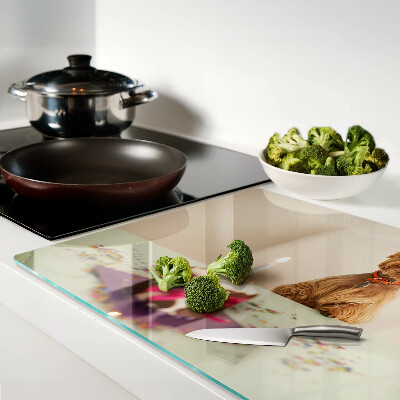 Glass chopping board A dog at the table with a cake