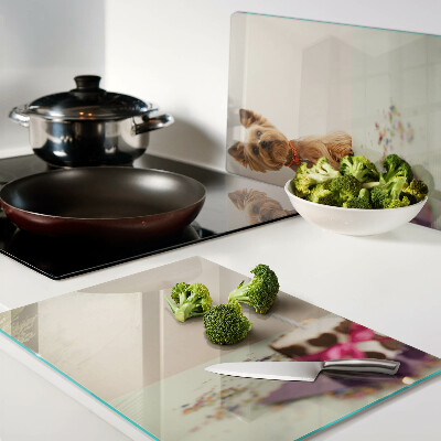 Glass chopping board A dog at the table with a cake