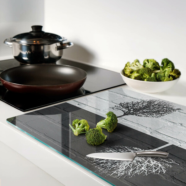 Glass chopping board A tree against a background of bricks