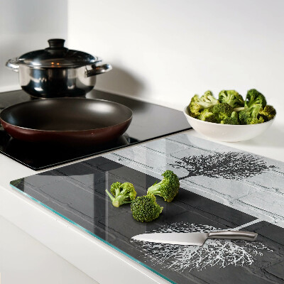 Glass chopping board A tree against a background of bricks