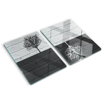 Glass chopping board A tree against a background of bricks
