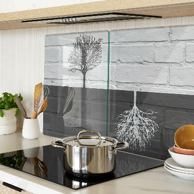 Glass chopping board A tree against a background of bricks