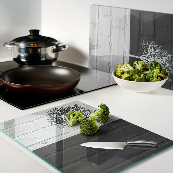 Glass chopping board A tree against a background of bricks