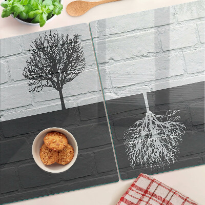 Glass chopping board A tree against a background of bricks