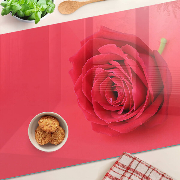 Cutting board Red rose on the background